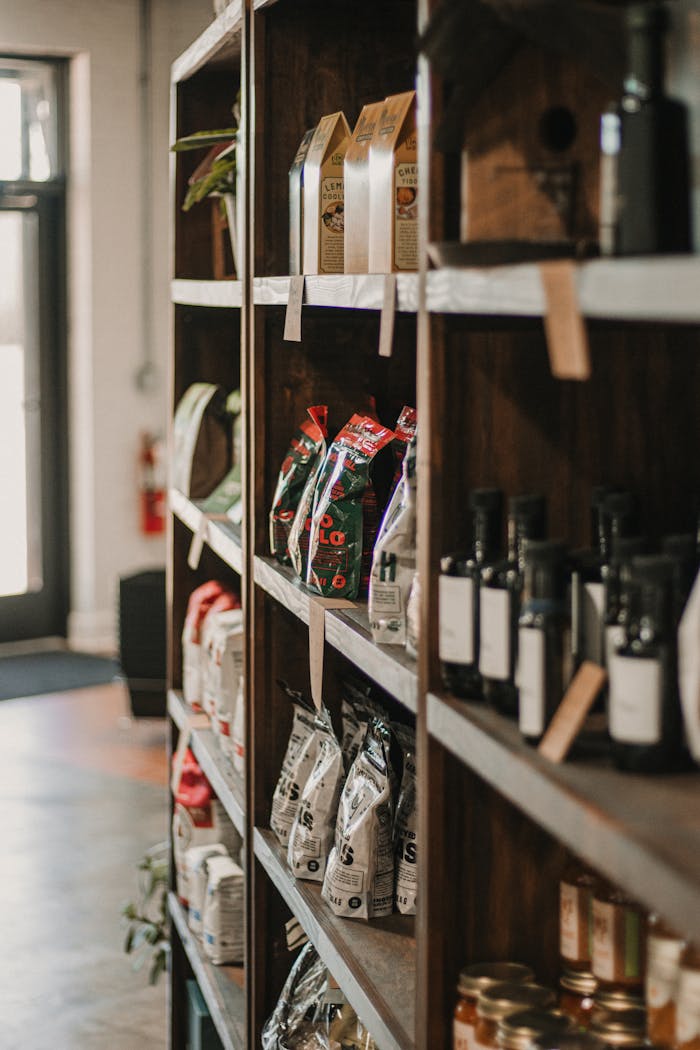 Shelves with assorted artisan products in a cozy local store environment.
